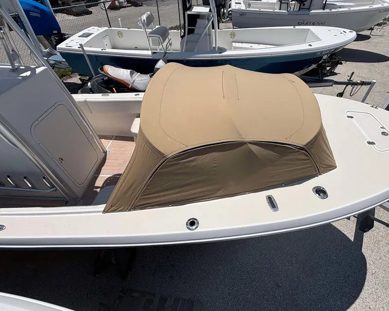 Slide: The Image of 2009 Andros Tarpon 26 boat with tan cover, docked among other boats. - 8