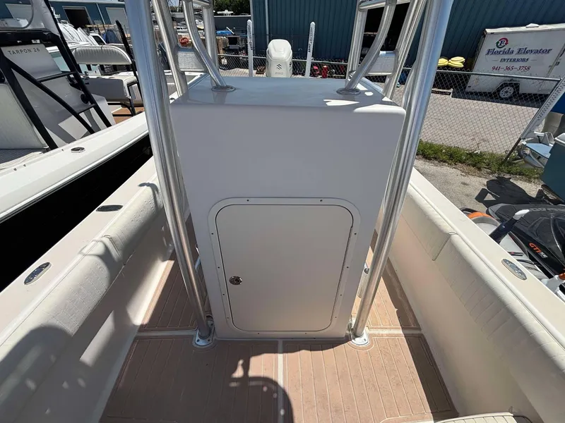 Slide: The Image of 2009 Andros Tarpon 26 boat console with storage compartment, docked outdoors. - 10