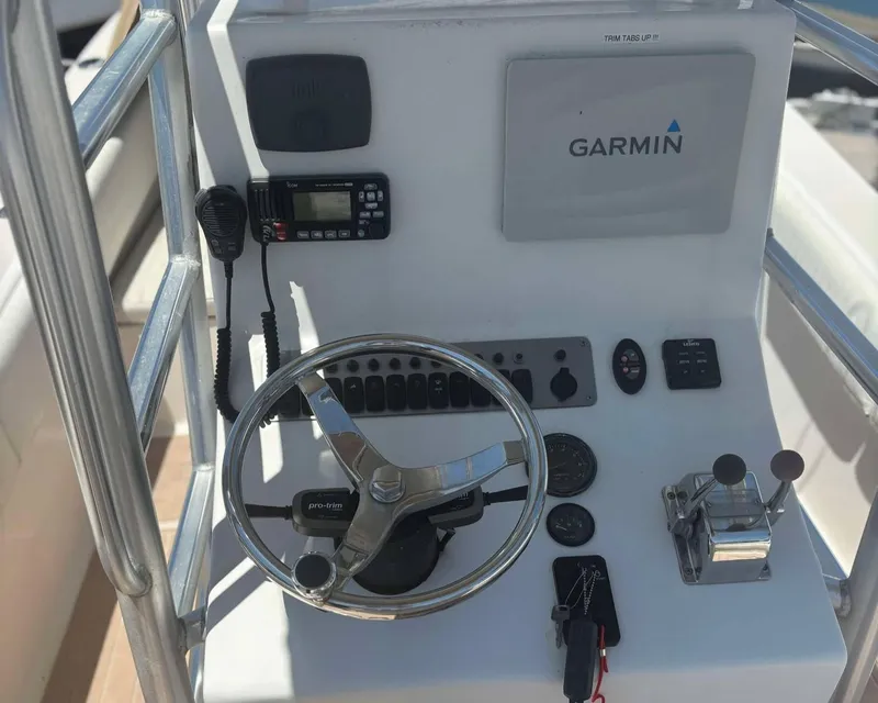 Slide: The Image of 2009 Andros Tarpon 26 boat console with Garmin navigation and steering wheel. - 14
