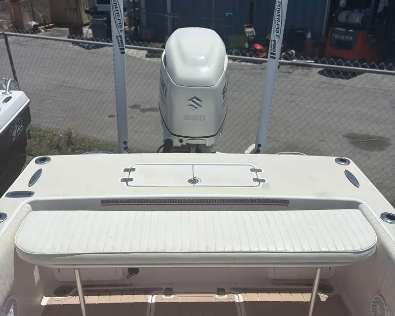 Slide: The Image of 2009 Andros Tarpon 26 boat with Suzuki outboard motor, docked near a chain-link fence. - 17