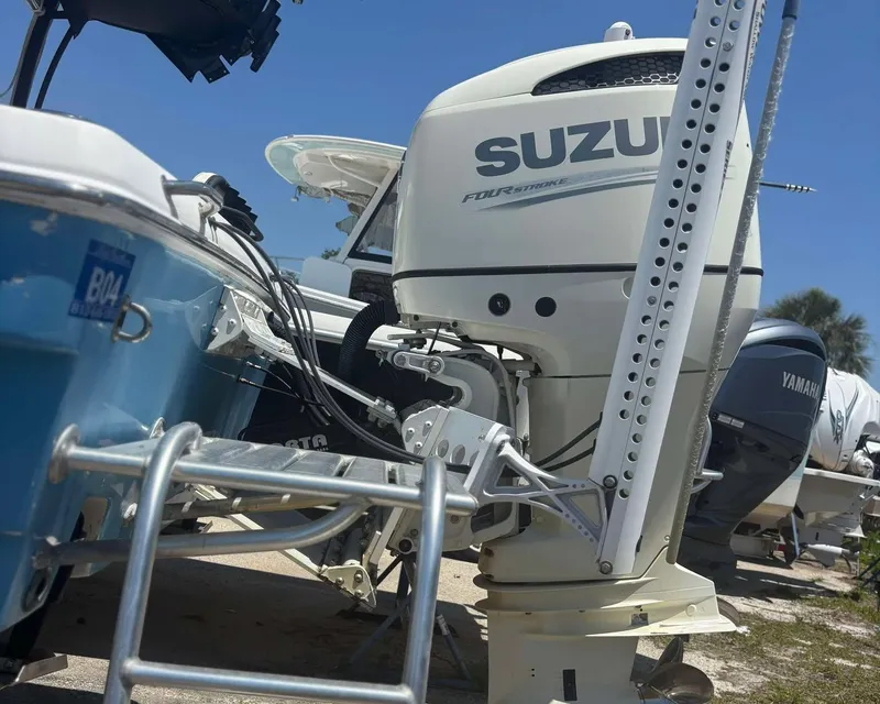 Slide: The Image of 2009 Andros Tarpon 26 boat with Suzuki outboard motor, docked under clear blue sky. - 19
