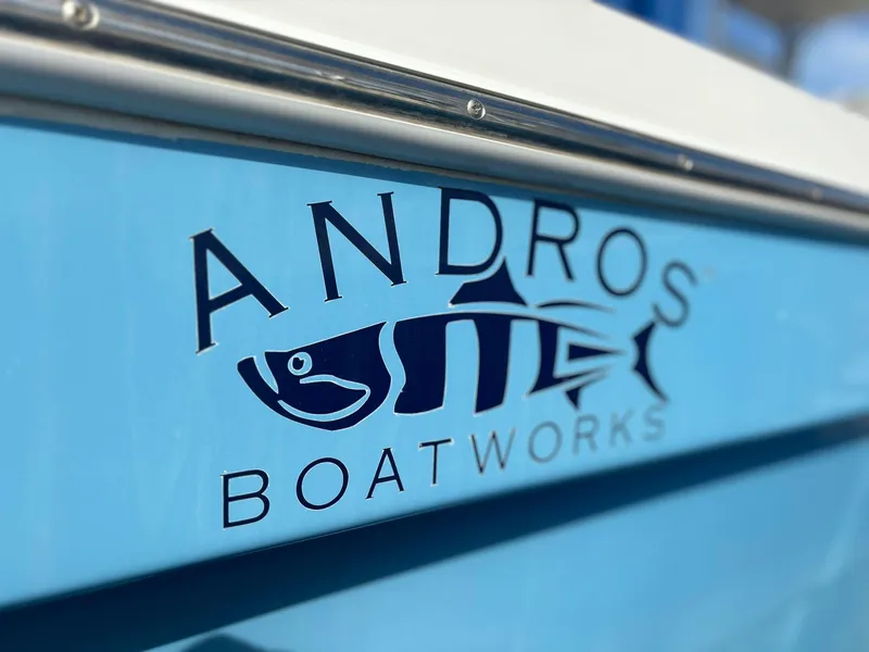 Slide: The Image of 2009 Andros Tarpon 26 boat with Andros Boatworks logo on blue hull. - 2