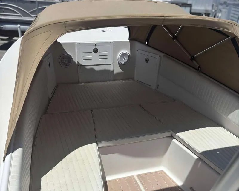 Slide: The Image of 2009 Andros Tarpon 26 boat interior with beige canopy and seating. - 7