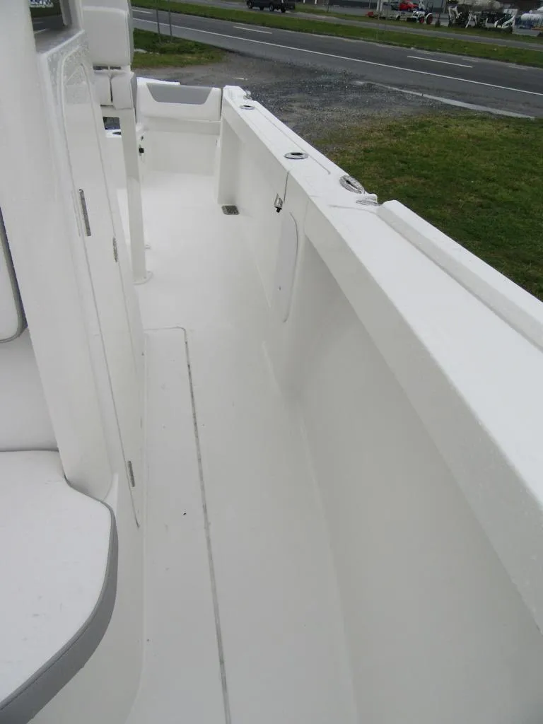 Slide: The Image of 2024 Parker 2200 Center Console boat deck, white interior, spacious layout. - 11