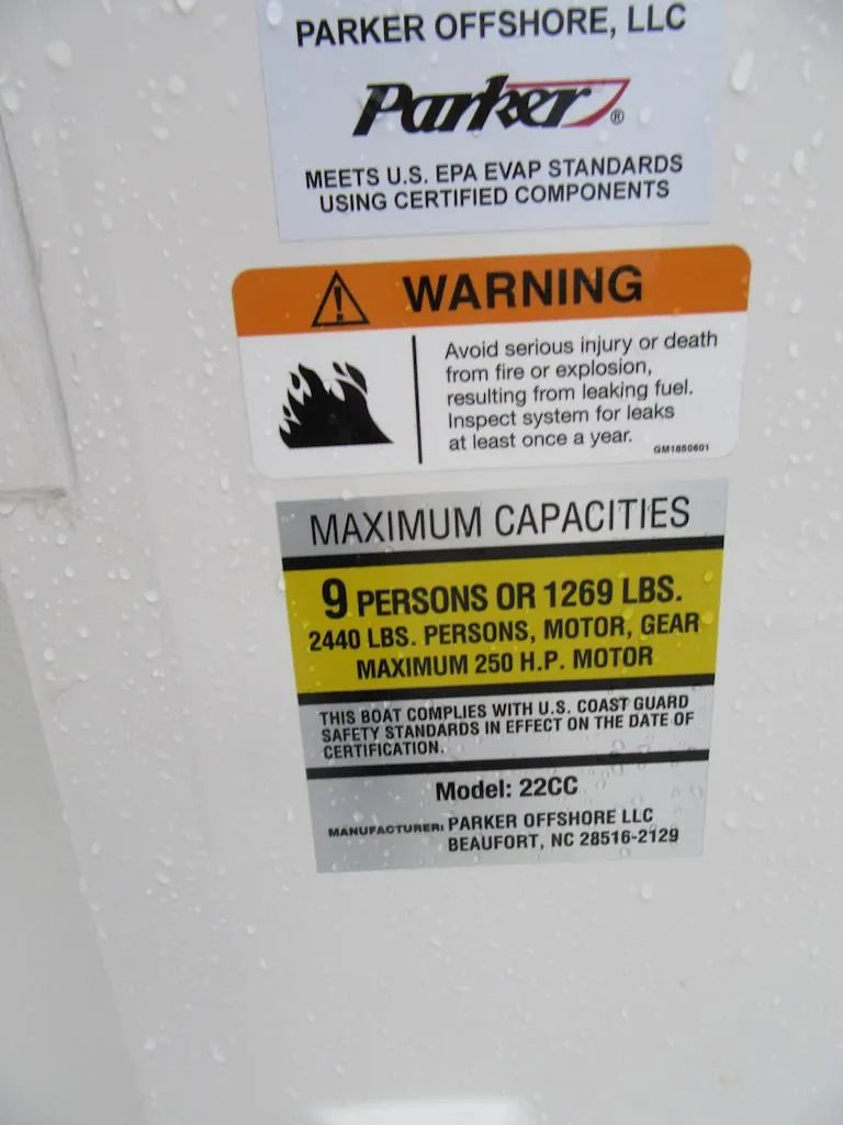 Slide: The Image of Parker 2200 Center Console 2024 warning and capacity label, 9 persons or 1269 lbs max. - 13