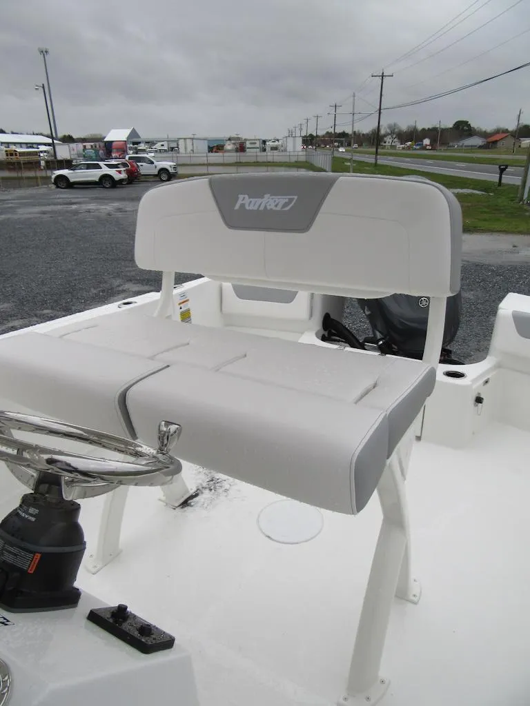 Slide: The Image of 2024 Parker 2200 Center Console boat with white seating and steering wheel. - 15