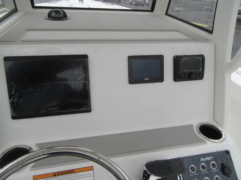 Slide: The Image of 2024 Parker 2200 Center Console boat dashboard with navigation screens and controls. - 3