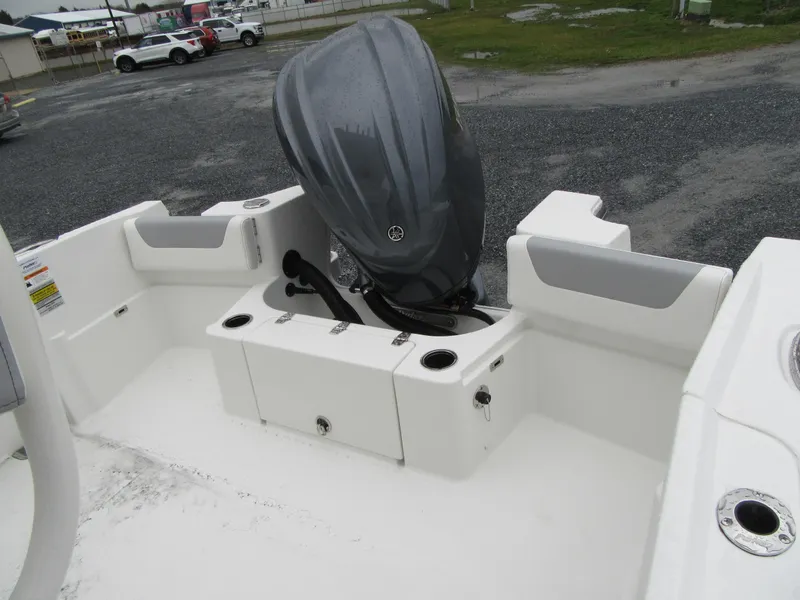 Slide: The Image of 2024 Parker 2200 Center Console boat with outboard motor in a parking lot. - 4