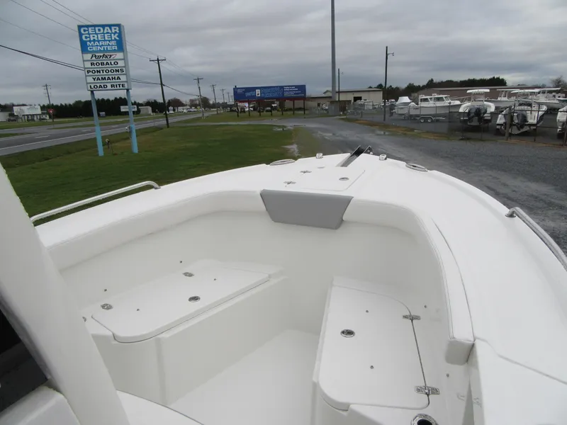 Slide: The Image of 2024 Parker 2200 Center Console boat, front seating area, dealership in background. - 5