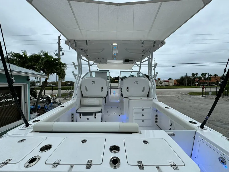 Slide: The Image of 2024 Edgewater 280cx boat interior with seating and storage compartments. - 10