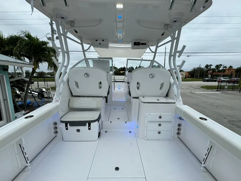 Slide: The Image of 2024 Edgewater 280cx boat interior with seating and storage compartments. - 11