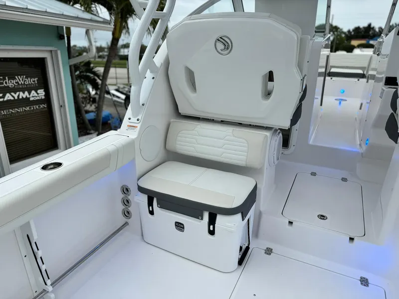 Slide: The Image of 2024 Edgewater 280cx boat interior with white seating and storage. - 14