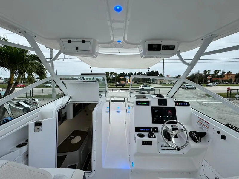 Slide: The Image of 2024 Edgewater 280cx boat interior with modern cockpit and navigation controls. - 17