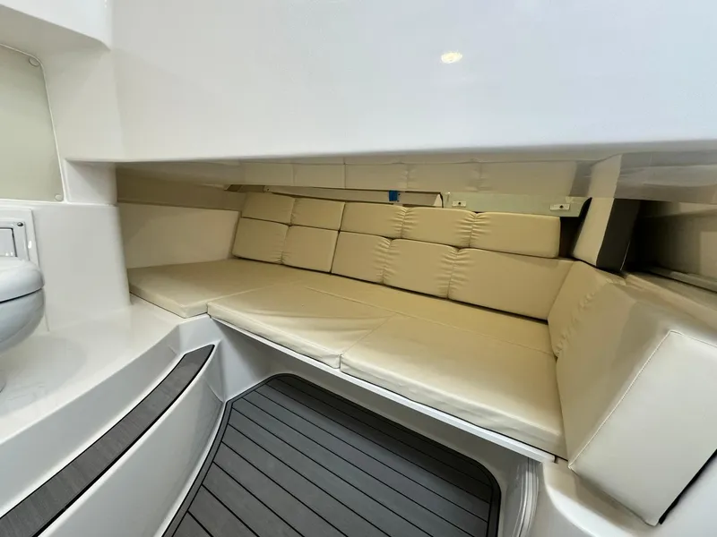 Slide: The Image of 2024 Edgewater 280cx cabin interior with cushioned seating and modern design. - 25