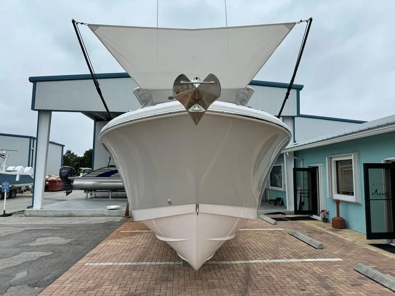 Slide: The Image of 2024 Edgewater 280cx boat displayed at a marina. - 3