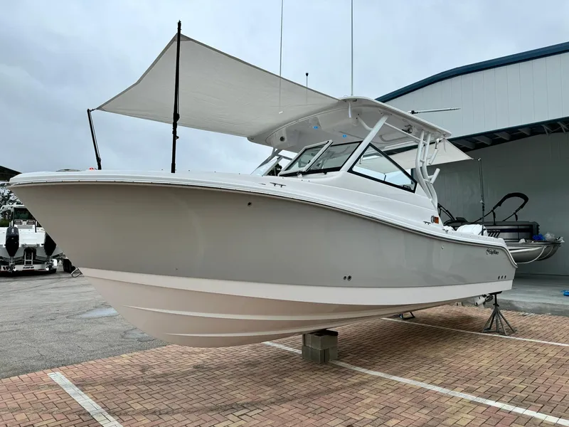 Slide: The Image of 2024 Edgewater 280cx boat displayed on a stand in a marina. - 5