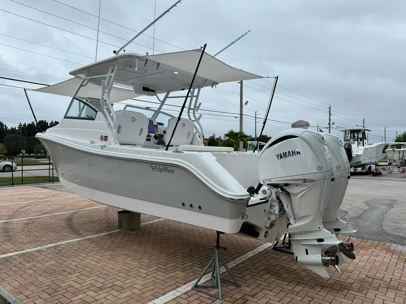 Slide: The Image of 2024 Edgewater 280cx boat with dual Yamaha engines on display. - 6