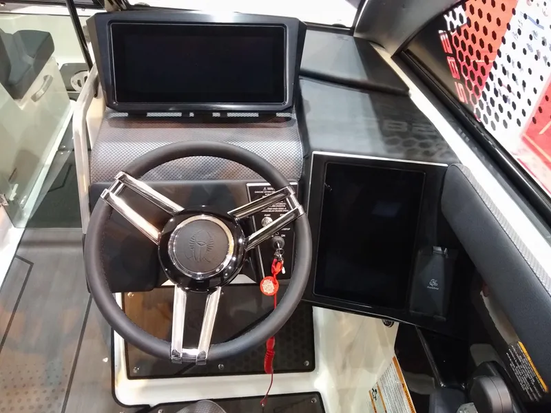 Slide: The Image of 2024 Scarab 285 Wake ID boat dashboard with steering wheel and digital displays. - 5