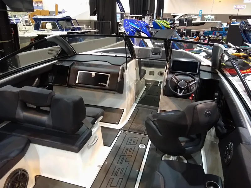 Slide: The Image of 2024 Scarab 285 Wake ID boat interior with modern seating and dashboard at a boat show. - 6