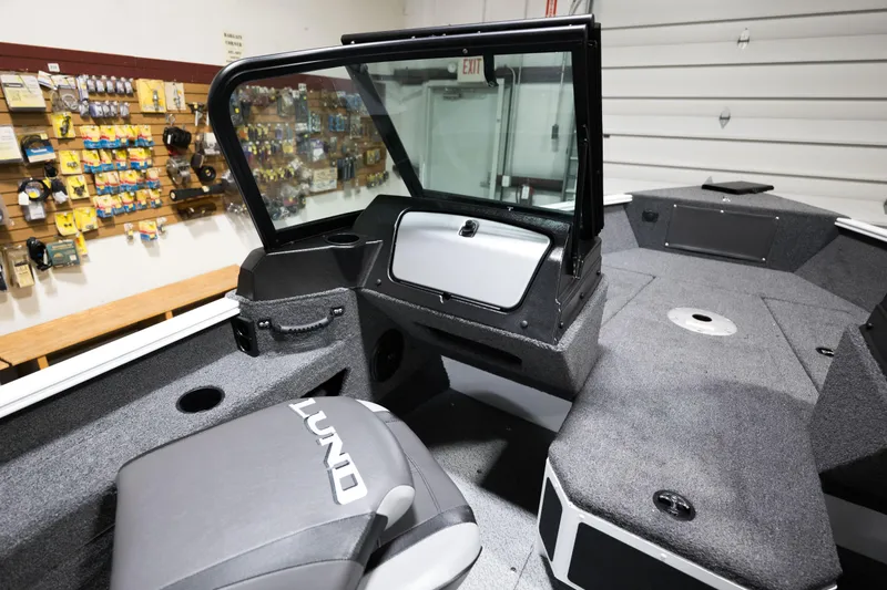 Slide: The Image of 2024 Lund 1675 Adventure Sport boat interior with seating and storage compartments. - 17
