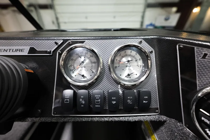 Slide: The Image of Dashboard of 2024 Lund 1675 Adventure Sport boat with gauges and control switches. - 19