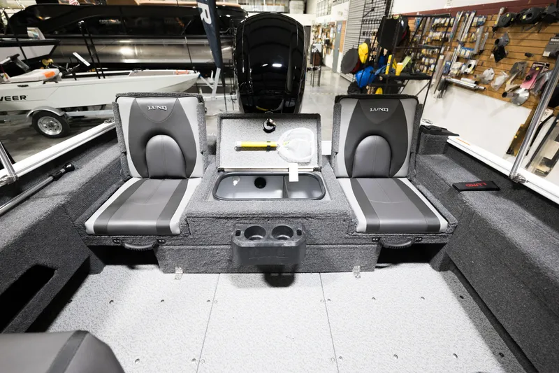 Slide: The Image of 2024 Lund 1675 Adventure Sport boat interior with seating and storage compartments. - 21