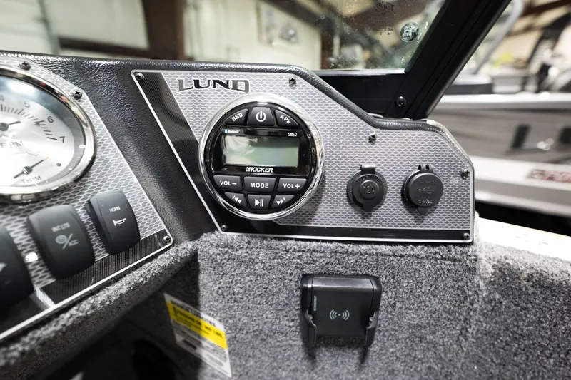 Slide: The Image of 2024 Lund 1675 Adventure Sport dashboard with audio controls and gauges. - 24