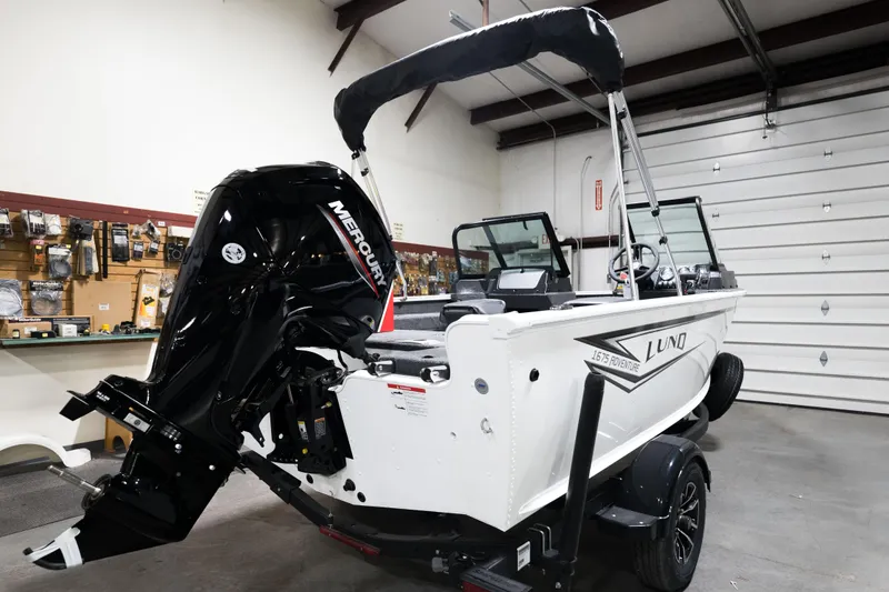Slide: The Image of 2024 Lund 1675 Adventure Sport boat with Mercury outboard motor in a garage. - 25