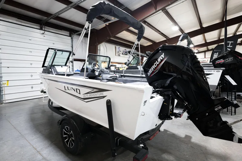 Slide: The Image of 2024 Lund 1675 Adventure Sport boat with Mercury outboard motor in showroom. - 26