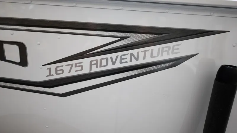 Slide: The Image of 2024 Lund 1675 Adventure Sport boat decal on white exterior. - 3