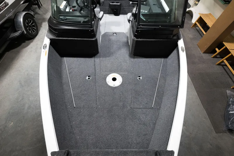 Slide: The Image of 2024 Lund 1675 Adventure Sport boat interior with carpeted deck and windshield. - 8