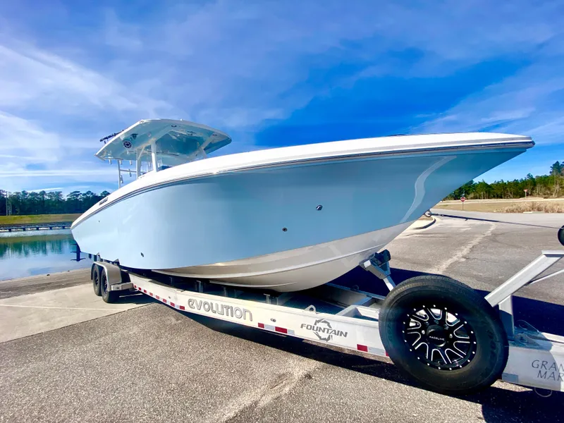 Slide: The Image of 2022 Fountain 34 Tournament Edition boat on trailer at marina. - 11