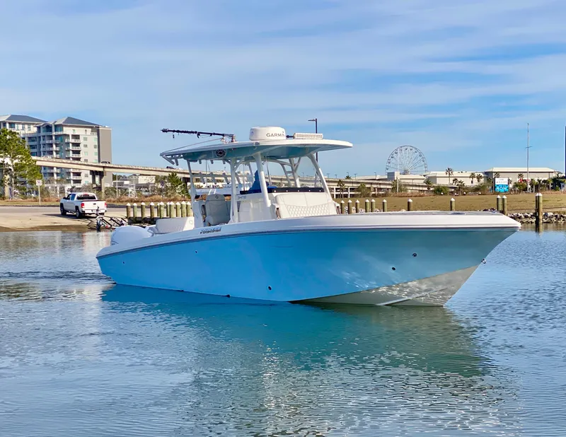 Slide: The Image of 2022 Fountain 34 Tournament Edition boat on calm water near a marina. - 12