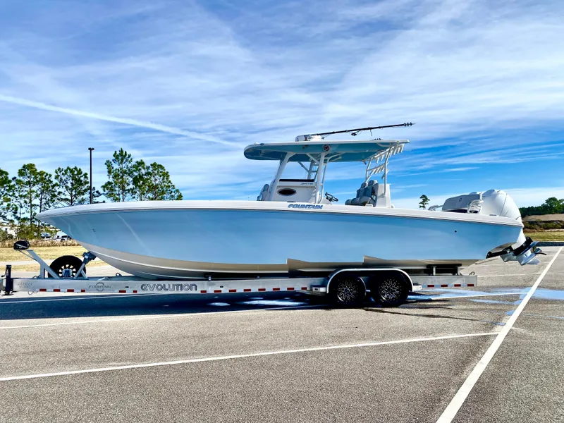Slide: The Image of 2022 Fountain 34 Tournament Edition boat on a trailer in a parking lot. - 14
