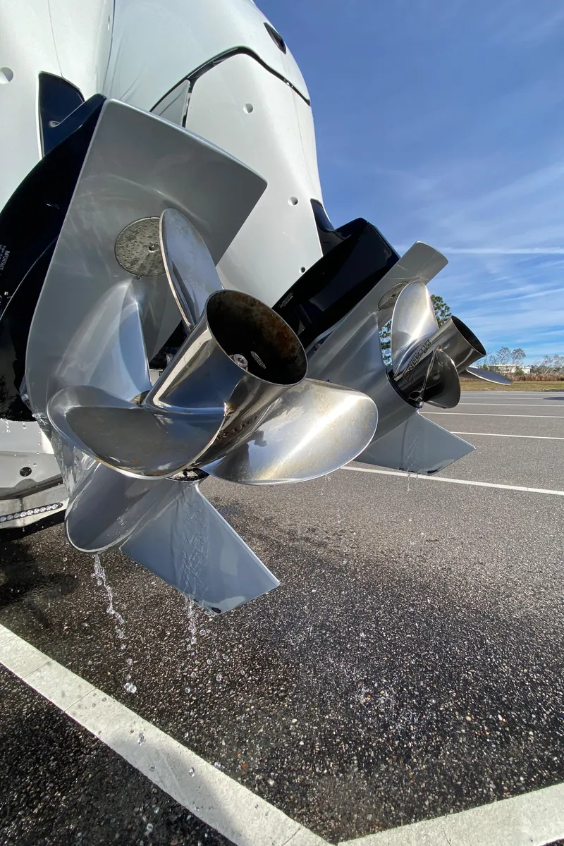 Slide: The Image of 2022 Fountain 34 Tournament Edition boat propellers in a parking lot. - 17