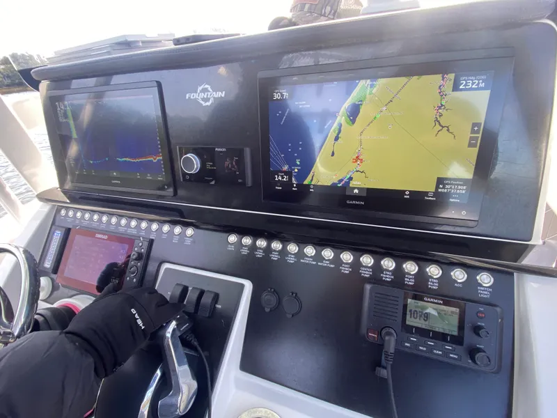 Slide: The Image of Control panel of a 2022 Fountain 34 Tournament Edition boat with navigation screens. - 20