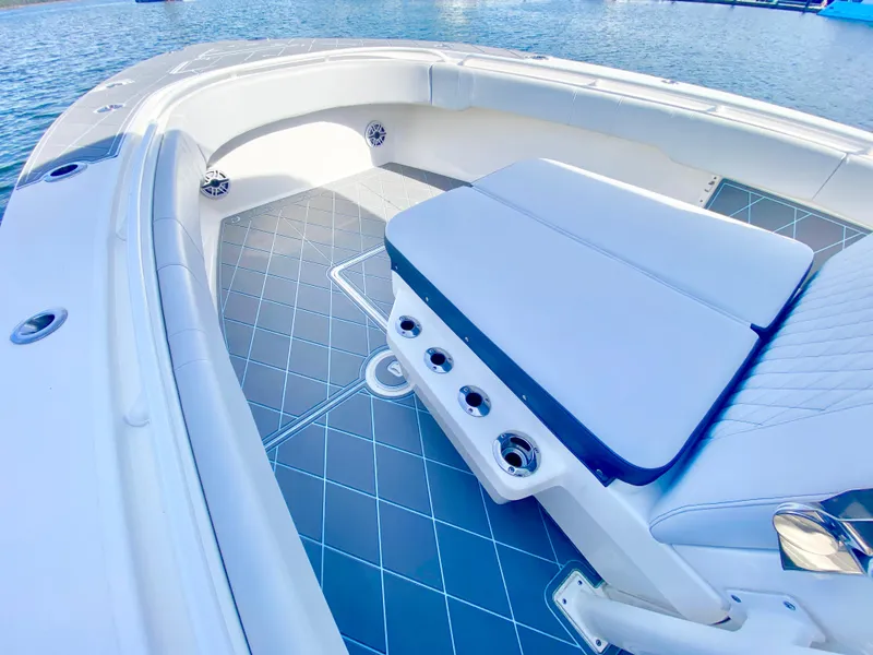 Slide: The Image of 2022 Fountain 34 Tournament Edition boat interior with cushioned seating and diamond-patterned flooring. - 23