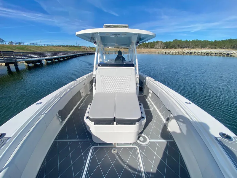 Slide: The Image of 2022 Fountain 34 Tournament Edition boat on calm water with clear blue sky. - 24