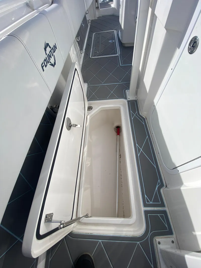 Slide: The Image of 2022 Fountain 34 Tournament Edition boat with open storage compartment. - 29