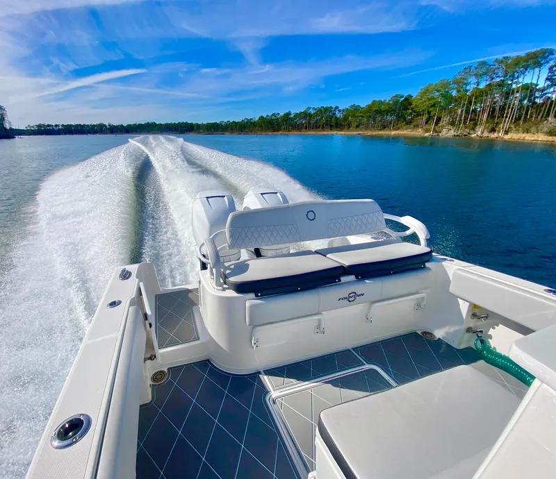 Slide: The Image of 2022 Fountain 34 Tournament Edition boat cruising on a serene lake. - 33