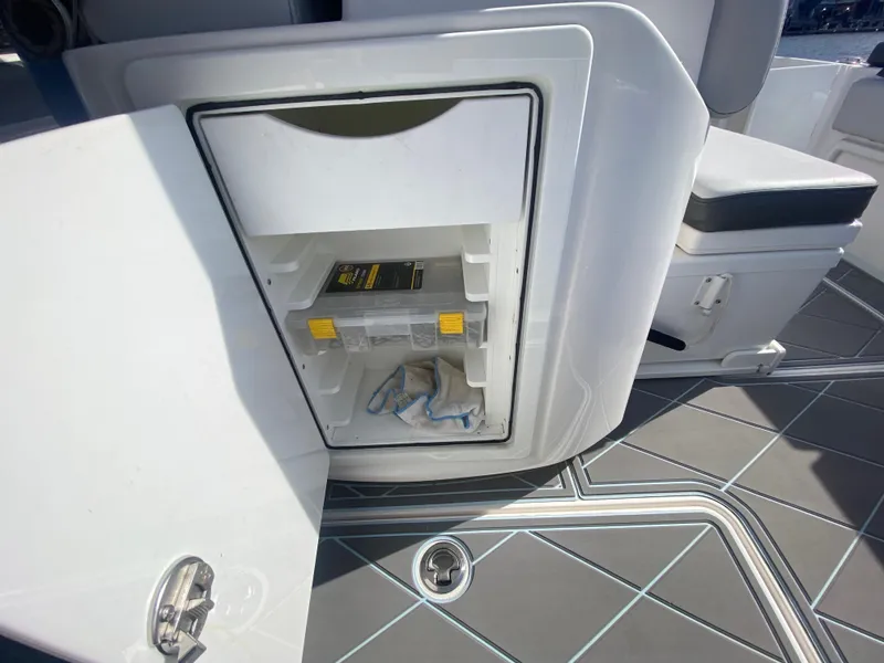 Slide: The Image of Open storage compartment on a 2022 Fountain 34 Tournament Edition boat. - 34