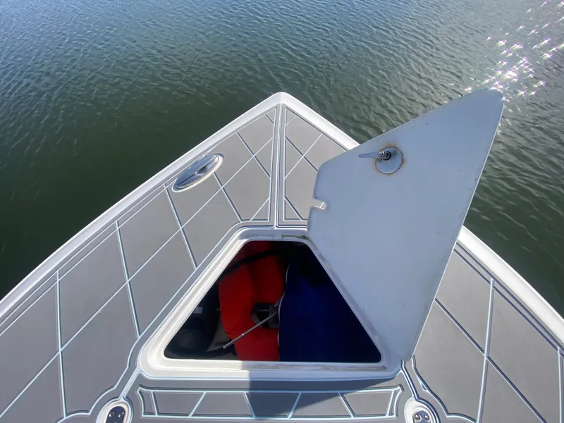 Slide: The Image of 2022 Fountain 34 Tournament Edition boat with open storage compartment on the bow. - 35