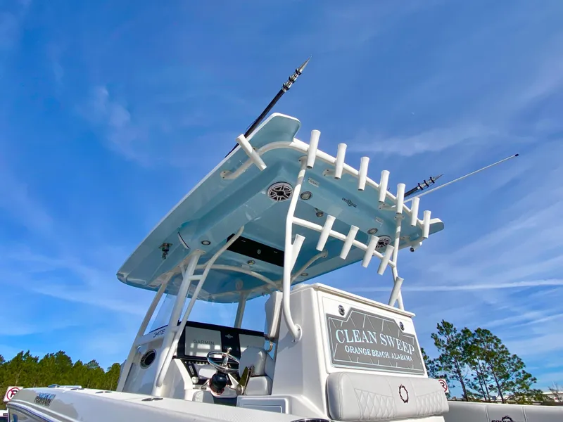 Slide: The Image of 2022 Fountain 34 Tournament Edition boat with fishing rods against a clear blue sky. - 38