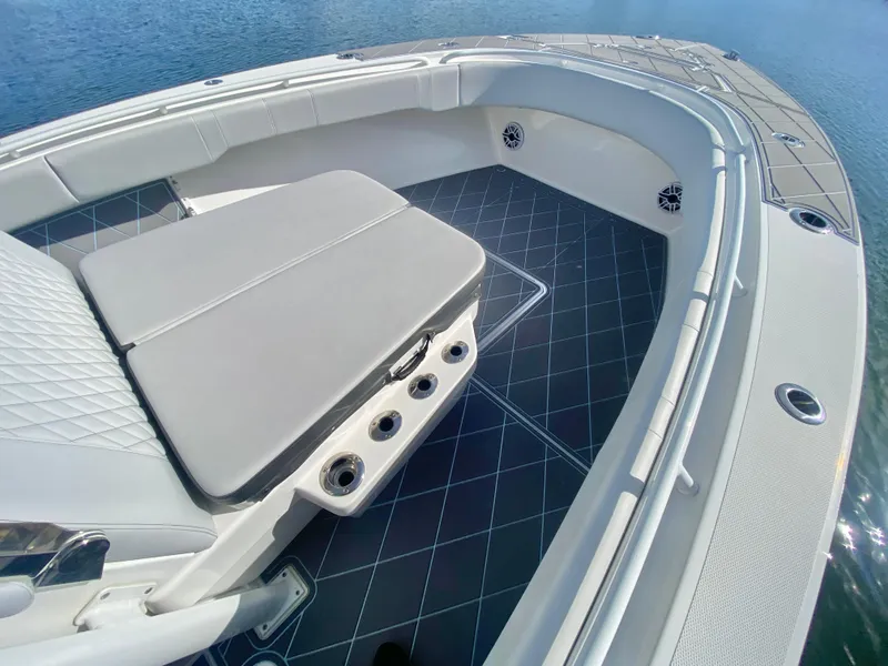 Slide: The Image of 2022 Fountain 34 Tournament Edition boat interior with cushioned seating and rod holders. - 43