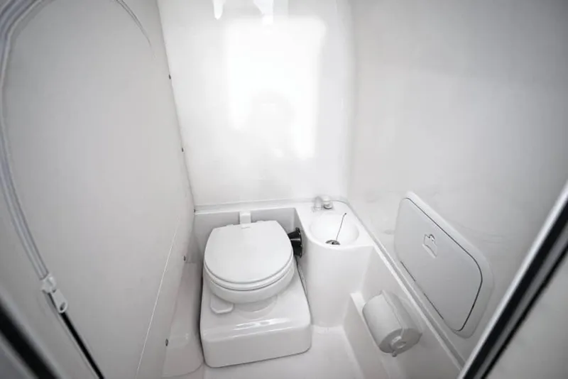 Slide: The Image of 2022 Fountain 34 Tournament Edition boat bathroom with toilet and storage. - 49