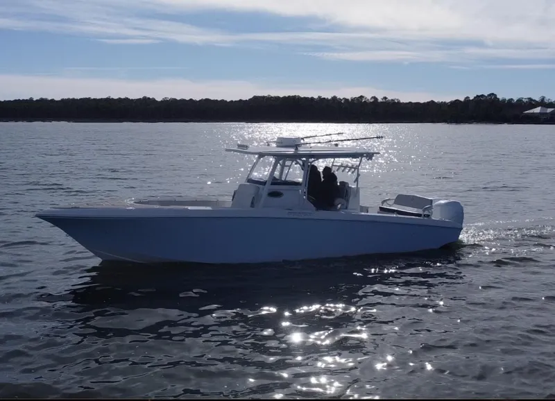 Slide: The Image of 2022 Fountain 34 Tournament Edition boat cruising on a calm lake. - 5