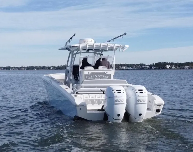 Slide: The Image of 2022 Fountain 34 Tournament Edition boat on water with twin engines. - 6