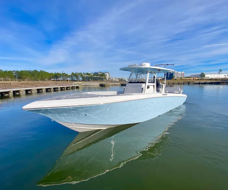 Slide: The Image of 2022 Fountain 34 Tournament Edition boat on calm water near a dock. - 9