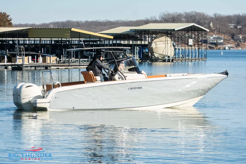 Slide: The Image of 2024 Capoforte FX270 boat cruising near docks on a calm lake. - 10