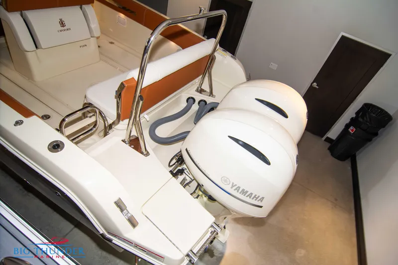 Slide: The Image of 2024 Capoforte FX270 boat with twin Yamaha outboard engines in a showroom. - 17